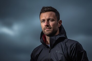 Obraz premium Headshot portrait photography of a glad boy in his 30s wearing a comfortable tracksuit against a dramatic thunderstorm background. With generative AI technology