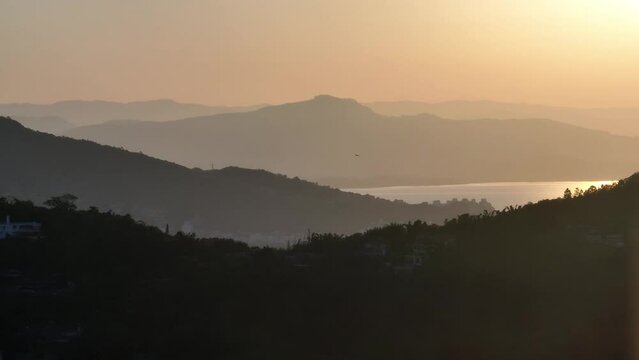 Lagoa da Conceicao in Florianopolis, Brazil. Amazing Aerial image. View of mountains during backlit sunset.