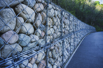 Stone fence with iron bars near the sidewalk
