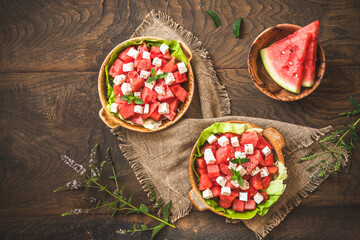 Fresh watermelon salad with feta cheese and mint on rustic wooden background