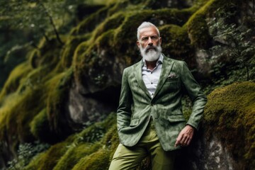 Urban fashion portrait photography of a glad mature man wearing a chic jumpsuit against a moss-covered forest background. With generative AI technology