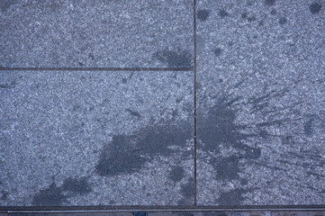 dirty pavement stone block, food or drink splash on ground
