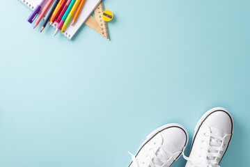 Learning essentials composition. Creative top view photograph featuring a pair of sneakers and an array of educational supplies on a pastel blue background. Ideal for text or promotional content - Powered by Adobe