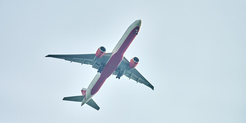 Airplane flying in blue sky copy space, large passenger plane flies in blue sky, fast comfortable safe transportation of passengers, departure allowed concept, view from below