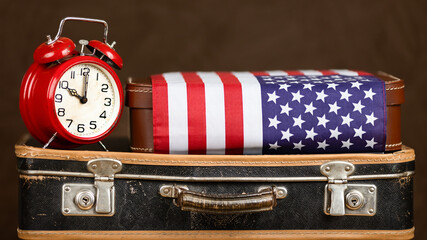 Vintage suitcase with alarm clock and flag. Travel, journey, holiday or moving to USA banner.
