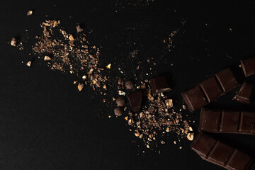 Chunky chocolate on black background.