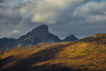 Dramatic light and clouds over mountain peaks of northern norway