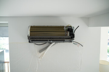Installation air conditioning system on white wall in apartment, office closeup. Technology...