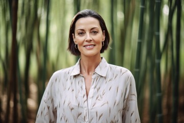 Medium shot portrait photography of a glad mature woman wearing a sophisticated blouse against a tranquil bamboo grove background. With generative AI technology