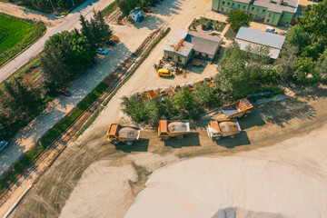 Panorama aerial view machinery and heavy-duty equipments at large construction site. Top of...