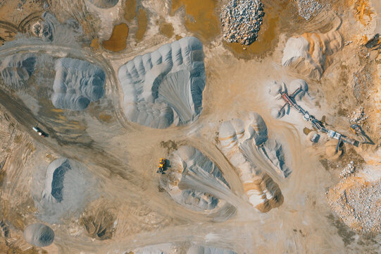 Pile of sand and rock or gravel in site, concrete plant in aerial view. Heap of aggregate or material from nature, mine or quarry for ready mix of cement, concrete. Builder using in construction.