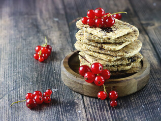No sugar berry crackers made of whole grain flour, sweetener and fresh berries, healthy snack. Red currant cookies, copy space. Pastry with berries. Appetizing cookies with fresh red currants