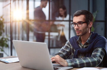 business man working on laptop in modern office.