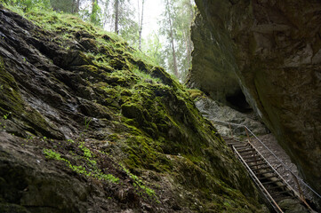 Stainless steel ladder to the cave, Deer Ruchy Nature Park in the Sverdlovsk region, Karstovy Bridge rock.
