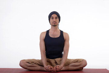 Man doing yoga in photo studio on isolated white background.