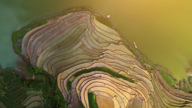 Aerial view of the water season makes the terraced fields of Y Ty commune, Lao Cai province, Vietnam appear with brown soil blending with the beautiful sky.
