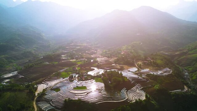 Aerial view of the water season makes the terraced fields of Y Ty commune, Lao Cai province, Vietnam appear with brown soil blending with the beautiful sky.