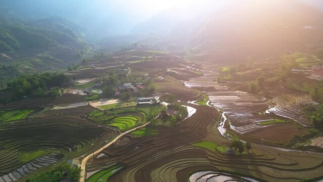 Aerial view of the water season makes the terraced fields of Y Ty commune, Lao Cai province, Vietnam appear with brown soil blending with the beautiful sky.