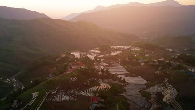 Aerial view of the water season makes the terraced fields of Y Ty commune, Lao Cai province, Vietnam appear with brown soil blending with the beautiful sky.