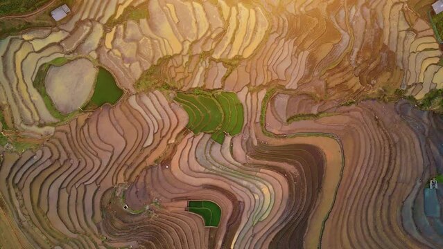 Aerial view of the water season makes the terraced fields of Y Ty commune, Lao Cai province, Vietnam appear with brown soil blending with the beautiful sky.