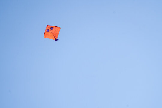 Red kite flying against blue sky on independence day in India in delhi 6 showing this popular celebration