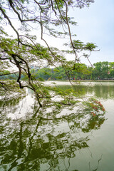 view of The Huc Red Bridge and Ngoc Son temple in the center of Hoan Kiem Lake, Ha Noi, Vietnam.