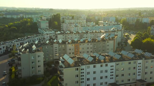 Aerial View of Solar Panels Roof of Residential Apartment Buildings for the Production of Green Electricity. Solar Panels on the Roof. Town in Europe Uses Renewable Energy Sources for the Power Grid.