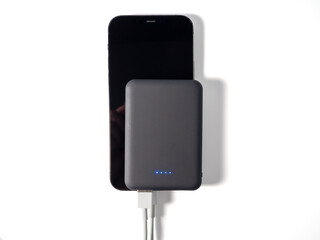 Power bank for charging mobile devices on a white background. Smartphone charger with power supply....