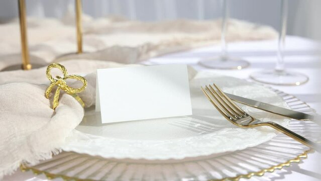 Video place card mockup with gold accessories on table