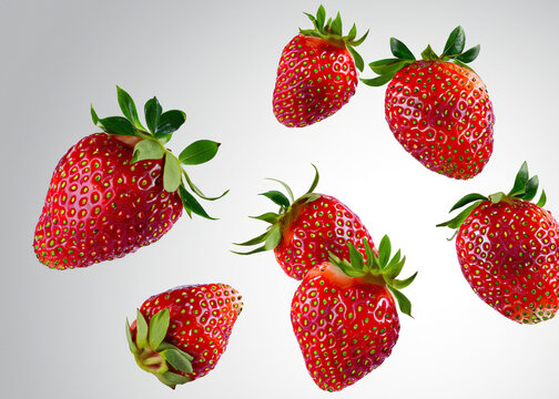 Floating Strawberry: Juicy Red Berry Levitating on a White Background - Refreshing and Delicious Summer Fruit Concept