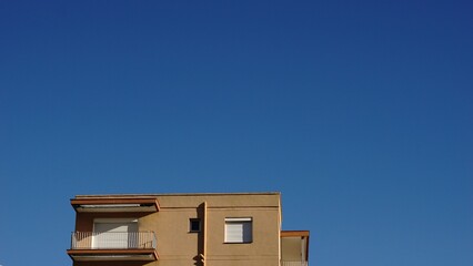 last floor of residential building facade against the sky