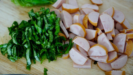 Closed up of basil leaves and sausages prepared for spaghetti                                 