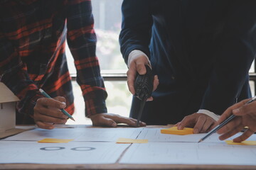 Construction and structure concept of Engineer or architect meeting for project working with partner and engineering tools on model building and blueprint in working site, contract for both companies.