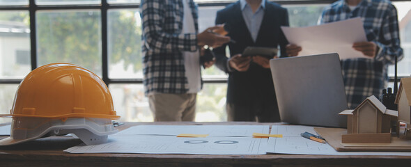 Construction and structure concept of Engineer or architect meeting for project working with partner and engineering tools on model building and blueprint in working site, contract for both companies.