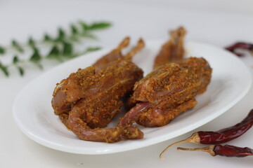 Marinated Quail meat. Quail meat marinated with red chili powder, pepper, ginger garlic paste, salt and lime juice before deep frying