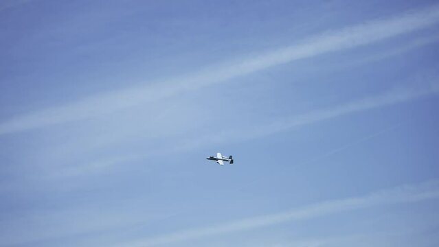 Military air plane fighter A-10 Thunderbolt fly against blue sky, slow motion