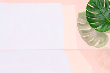 Abstract light pink background. The shadow of tropical plant leaves on a wall.
