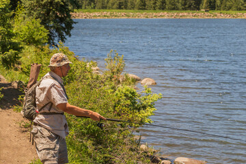 Senior 70 plus man fishing at a lake