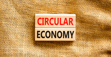 Circular economy symbol. Concept words Circular economy on wooden blocks. Beautiful canvas table...