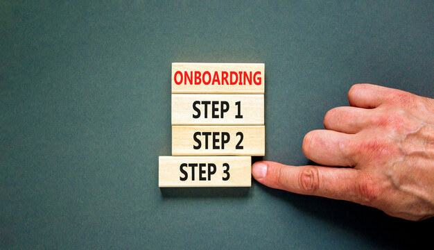 Time to step 3 onboarding symbol. Concept words Onboarding step 3 on wooden block. Businessman hand. Beautiful grey table grey background. Business success step 3 onboarding concept. Copy space.