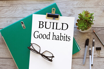Build good habits symbol. a4 paper. text on white page on folder