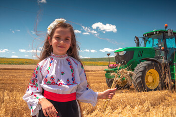Young girl with traditional Bulgarian folklore costume at the agricultural wheat field during...