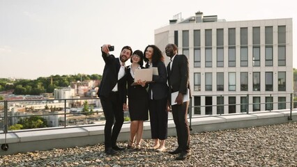 International group of people taking selfie on personal smartphone when meeting outdoors for business negotiations. Proud corporate partners with remote tools feeling happy to work together. - Powered by Adobe
