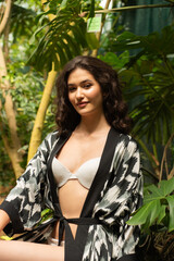 Beautiful young sensual woman wearing light summer dress on tropical resort