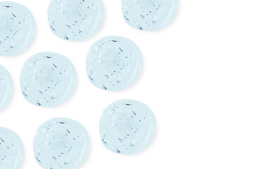 Composition of smears and drops or drops of a transparent blue gel, serum. On an empty transparent background.