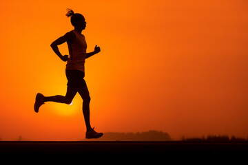Fototapeta na wymiar Running into the Sunrise - A Symbol of Endurance and Determination