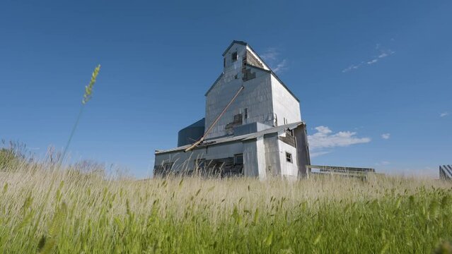 Wooden Grain Elevator Swaing Grass And Beautiful Skies