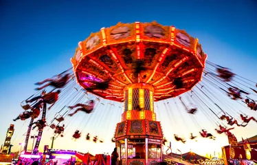Fotobehang Amusementspark Colorful rides and fun at sunset at the South Carolina State Fair in Columbia, SC 