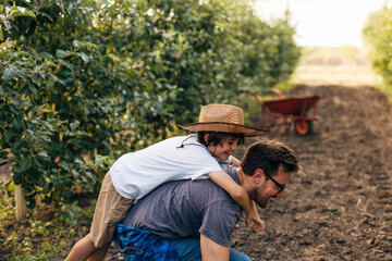 Father carries his son on his back.