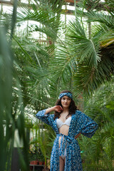 Beautiful woman on tropic resort. Wearing beachwear tunic